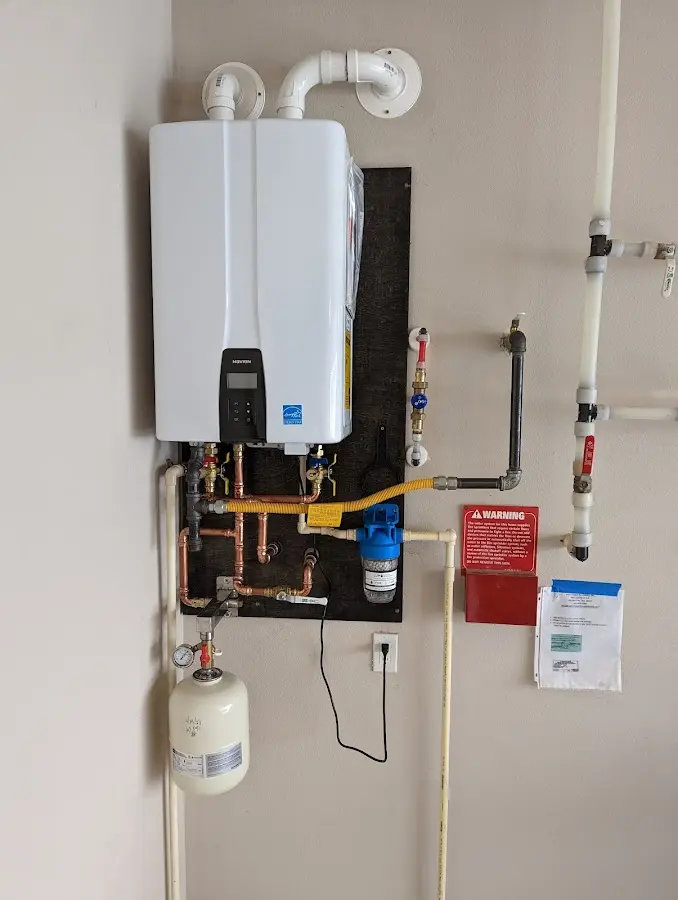 Professional plumber installing copper piping in a Kelly home